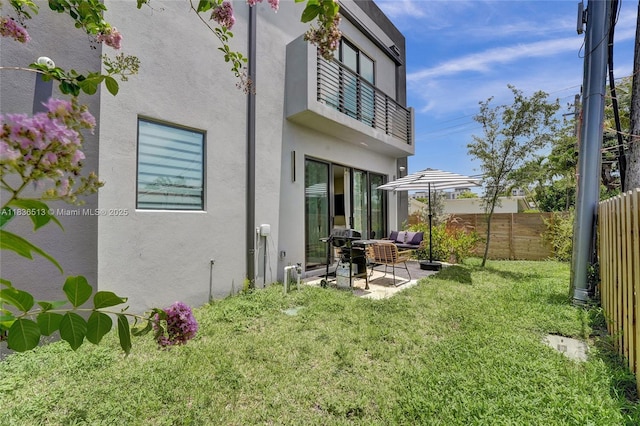 1617 NE 11th St Unit 1, Fort Lauderdale, FL 33304 - back of house with a fenced backyard, stucco siding, a patio, and an outdoor hangout area