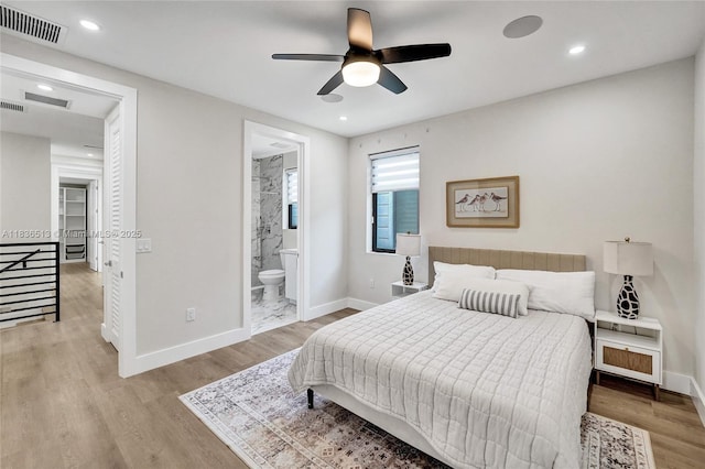 1617 NE 11th St Unit 1, Fort Lauderdale, FL 33304 - bedroom with wood finished floors, ensuite bath, recessed lighting, and ceiling fan