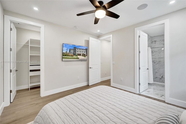 1617 NE 11th St Unit 1, Fort Lauderdale, FL 33304 - bedroom with a spacious closet, recessed lighting, light wood-style floors, a ceiling fan, and ensuite bathroom
