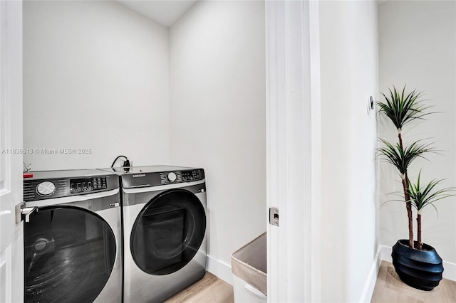 1617 NE 11th St Unit 1, Fort Lauderdale, FL 33304 - washroom with washing machine and clothes dryer and wood finished floors