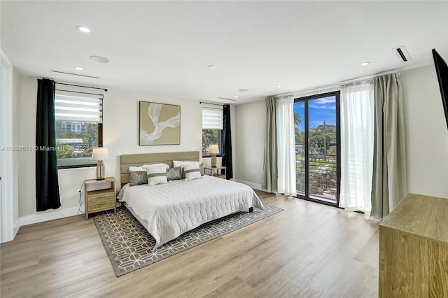 1617 NE 11th St Unit 1, Fort Lauderdale, FL 33304 - bedroom with access to exterior, light wood-style floors, and recessed lighting