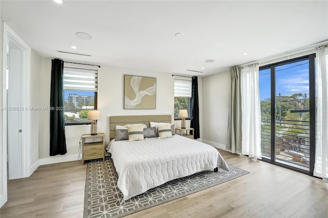 1617 NE 11th St Unit 1, Fort Lauderdale, FL 33304 - bedroom with multiple windows, light wood-type flooring, access to exterior, and recessed lighting