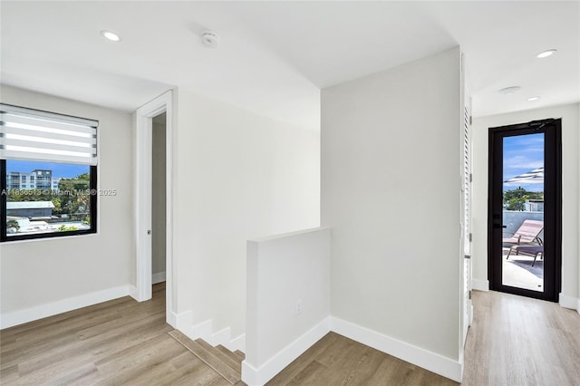 1617 NE 11th St Unit 1, Fort Lauderdale, FL 33304 - hallway featuring healthy amount of natural light, wood finished floors, an upstairs landing, and recessed lighting