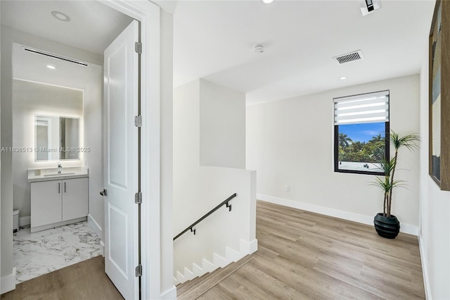 1617 NE 11th St Unit 1, Fort Lauderdale, FL 33304 - hall featuring an upstairs landing, recessed lighting, and light wood-style floors
