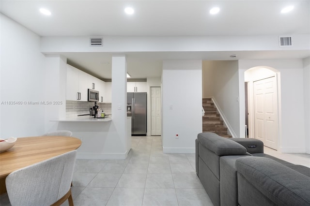 724 SW 106th Ave Unit 2010, Pembroke Pines, FL 33025 - kitchen featuring appliances with stainless steel finishes, light countertops, recessed lighting, light tile patterned flooring, and decorative backsplash