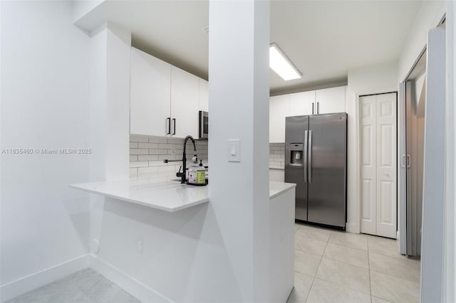 724 SW 106th Ave Unit 2010, Pembroke Pines, FL 33025 - kitchen featuring stainless steel fridge, tasteful backsplash, a peninsula, light countertops, and white cabinetry