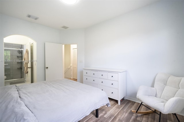 724 SW 106th Ave Unit 2010, Pembroke Pines, FL 33025 - bedroom with wood finished floors, arched walkways, and connected bathroom