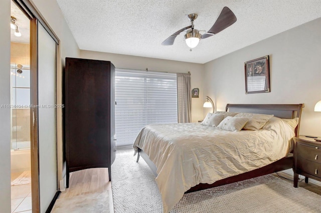 9715 NW 23rd Ct, Pembroke Pines, FL 33024 - bedroom with a textured ceiling, a ceiling fan, and ensuite bath