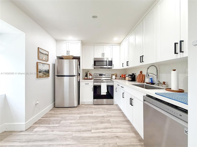 13790 SW 147th Cir Ln Unit 2-9, Miami, FL 33186 - kitchen with appliances with stainless steel finishes, white cabinets, light countertops, recessed lighting, and light wood finished floors