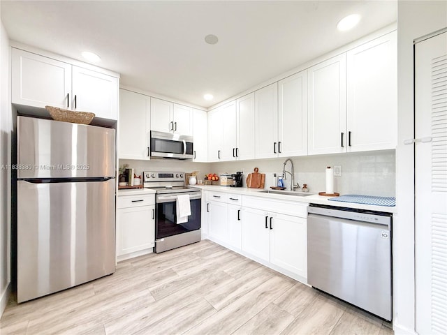 13790 SW 147th Cir Ln Unit 2-9, Miami, FL 33186 - kitchen featuring stainless steel appliances, white cabinetry, light countertops, recessed lighting, and light wood finished floors