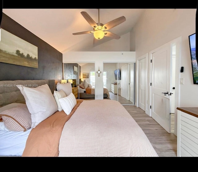 13790 SW 147th Cir Ln Unit 2-9, Miami, FL 33186 - bedroom featuring multiple closets, light wood finished floors, lofted ceiling, and a ceiling fan