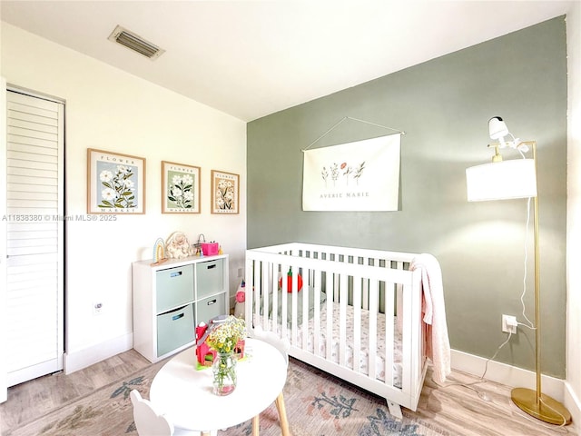 13790 SW 147th Cir Ln Unit 2-9, Miami, FL 33186 - bedroom featuring wood finished floors and a nursery area