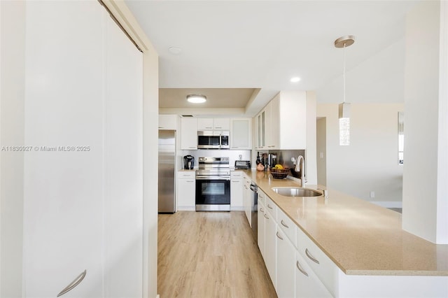 3200 N Port Royale Dr N Unit 1612, Fort Lauderdale, FL 33308 - kitchen featuring appliances with stainless steel finishes, white cabinetry, light stone countertops, a peninsula, and light wood-style floors