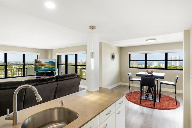 3200 N Port Royale Dr N Unit 1612, Fort Lauderdale, FL 33308 - kitchen featuring wood finished floors, plenty of natural light, white cabinets, light stone counters, and recessed lighting