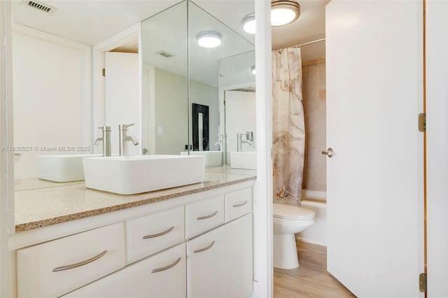 3200 N Port Royale Dr N Unit 1612, Fort Lauderdale, FL 33308 - bathroom with vanity, shower / bath combination with curtain, and wood finished floors