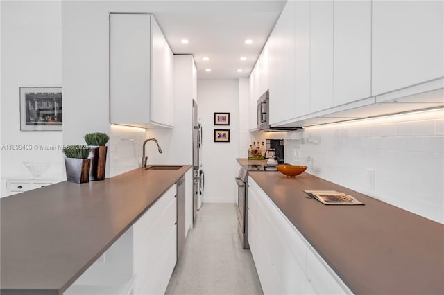 3 Island Ave Unit 12E, Miami Beach, FL 33139 - kitchen featuring stainless steel appliances, modern cabinets, white cabinetry, backsplash, and dark countertops