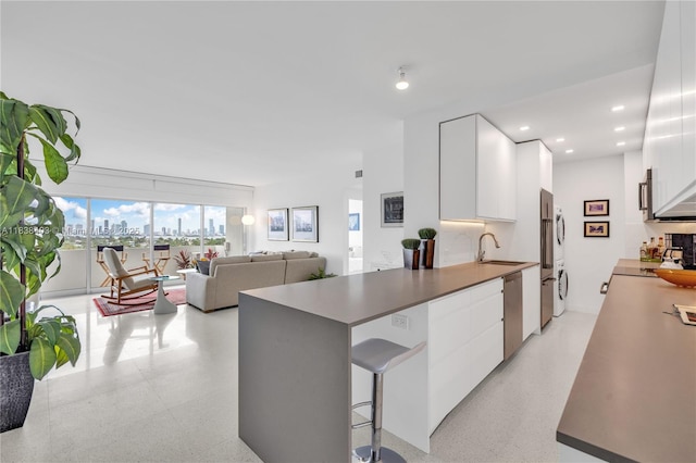 3 Island Ave Unit 12E, Miami Beach, FL 33139 - kitchen with modern cabinets, white cabinets, stainless steel appliances, a peninsula, and recessed lighting