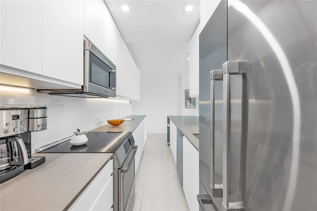 3 Island Ave Unit 12E, Miami Beach, FL 33139 - kitchen featuring appliances with stainless steel finishes, tasteful backsplash, white cabinetry, modern cabinets, and light countertops