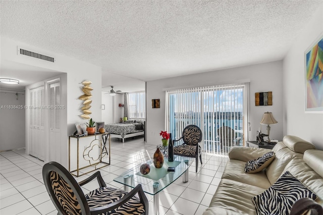 4001 Hillcrest Dr Unit 812, Hollywood, FL 33021 - living area featuring light tile patterned floors, healthy amount of natural light, and a textured ceiling