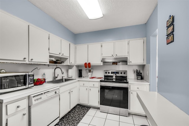 4001 Hillcrest Dr Unit 812, Hollywood, FL 33021 - kitchen featuring stainless steel appliances, light countertops, a textured ceiling, under cabinet range hood, and white cabinetry