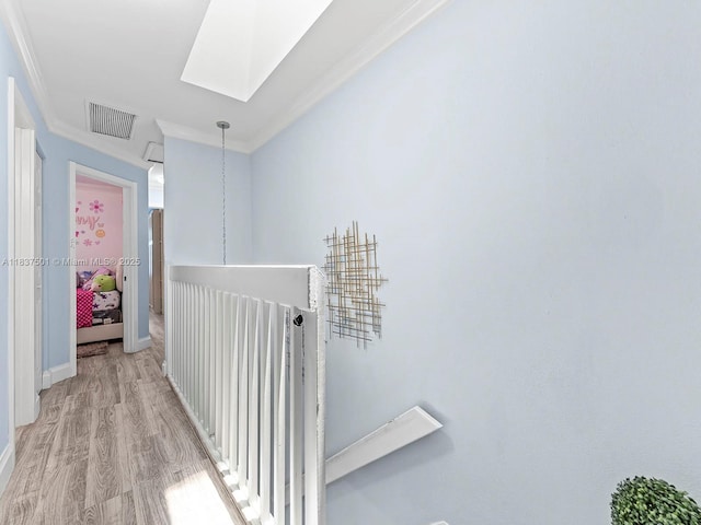 10942 W Sample Rd Unit E1, Coral Springs, FL 33065 - hallway featuring a skylight, crown molding, light wood-style flooring, and an upstairs landing