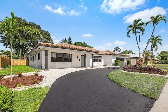 220 SW 75th Ter, Plantation, FL 33317 - mediterranean / spanish home with a tiled roof, driveway, stucco siding, and an attached garage