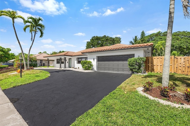 220 SW 75th Ter, Plantation, FL 33317 - mediterranean / spanish home with a tiled roof, stucco siding, a garage, and driveway