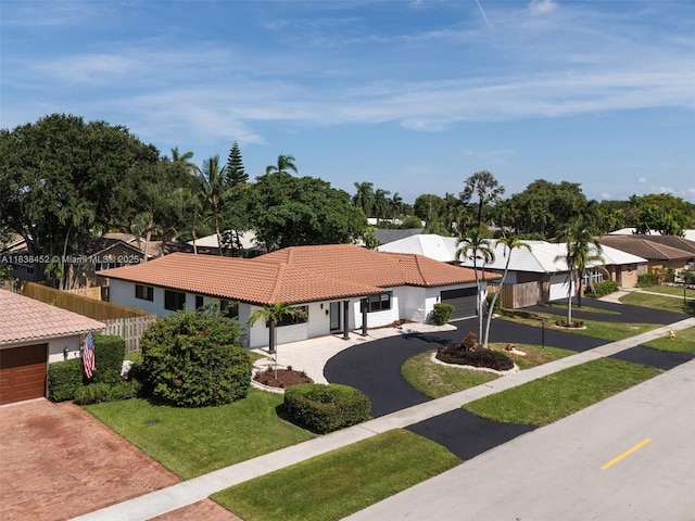 220 SW 75th Ter, Plantation, FL 33317 - view of front of property featuring decorative driveway, a tile roof, an attached garage, a residential view, and stucco siding