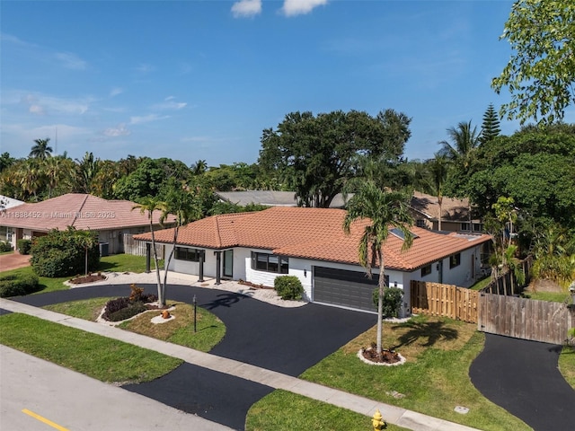 220 SW 75th Ter, Plantation, FL 33317 - view of front facade with a tile roof, driveway, a garage, and stucco siding