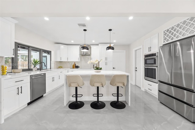 220 SW 75th Ter, Plantation, FL 33317 - kitchen featuring stainless steel appliances, a kitchen island, white cabinets, a breakfast bar, and light countertops