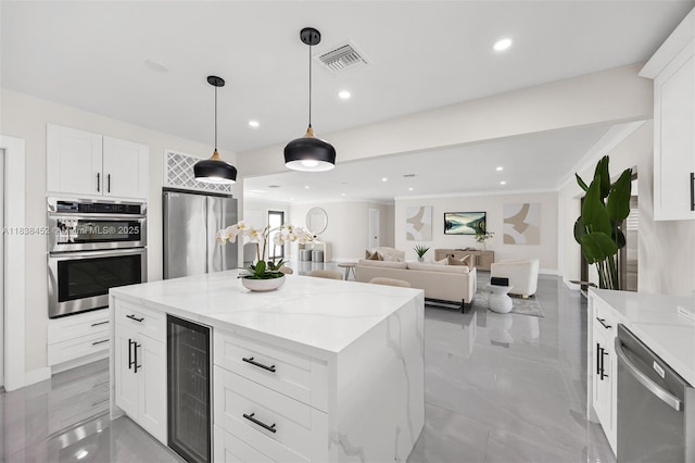 220 SW 75th Ter, Plantation, FL 33317 - kitchen with appliances with stainless steel finishes, wine cooler, a center island, light stone countertops, and pendant lighting