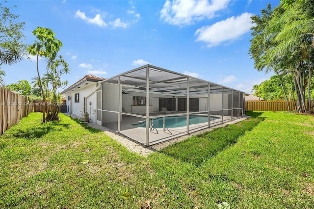 220 SW 75th Ter, Plantation, FL 33317 - back of property with a fenced backyard, a patio, glass enclosure, a tiled roof, and stucco siding