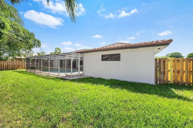 220 SW 75th Ter, Plantation, FL 33317 - rear view of property with stucco siding, a fenced backyard, a tiled roof, and a lanai