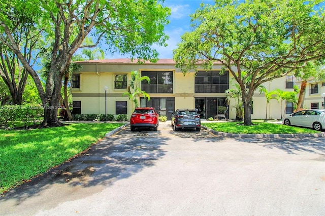 2880 S Carambola Cir S Unit 2071, Coconut Creek, FL 33066 - view of building exterior featuring uncovered parking