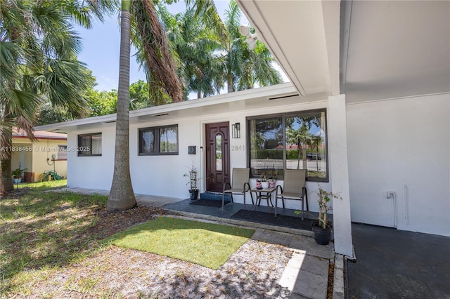 2841 NW 9th Ave, Wilton Manors, FL 33311 - view of exterior entry with covered porch and stucco siding