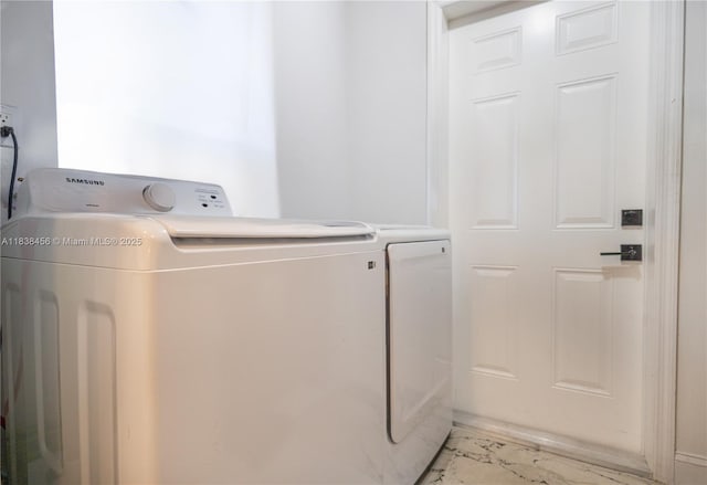 2841 NW 9th Ave, Wilton Manors, FL 33311 - laundry area featuring washing machine and clothes dryer and light marble finish floors