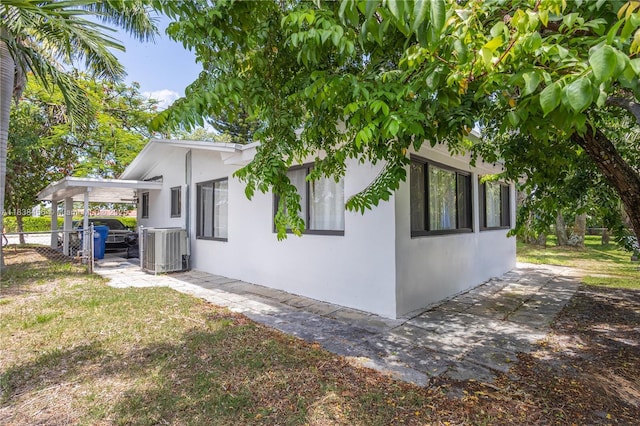 2841 NW 9th Ave, Wilton Manors, FL 33311 - view of property exterior with stucco siding and a central air condition unit