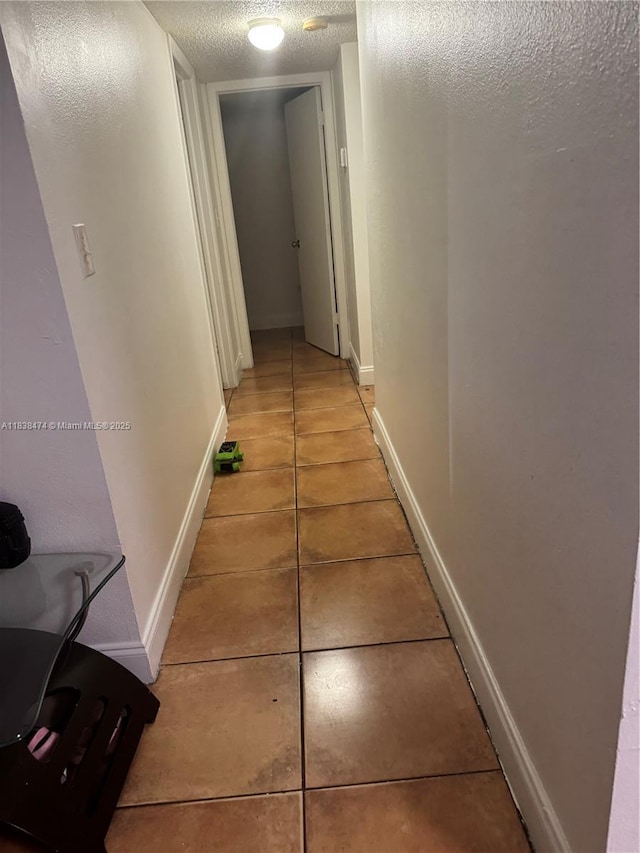 3610 NW 21st St Unit 413, Lauderdale Lakes, FL 33311 - corridor with a textured ceiling and light tile patterned floors