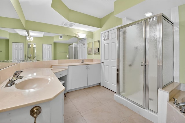 5938 Crystal Shores Dr Unit 103, Boynton Beach, FL 33437 - full bathroom with double vanity, a shower stall, tile patterned flooring, and a garden tub