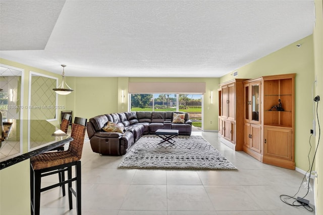 5938 Crystal Shores Dr Unit 103, Boynton Beach, FL 33437 - living room with a textured ceiling and light tile patterned floors