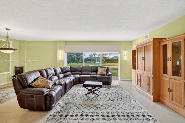 5938 Crystal Shores Dr Unit 103, Boynton Beach, FL 33437 - living room with light tile patterned floors and a textured ceiling