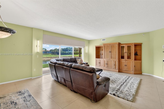 5938 Crystal Shores Dr Unit 103, Boynton Beach, FL 33437 - living room featuring light tile patterned floors and a textured ceiling