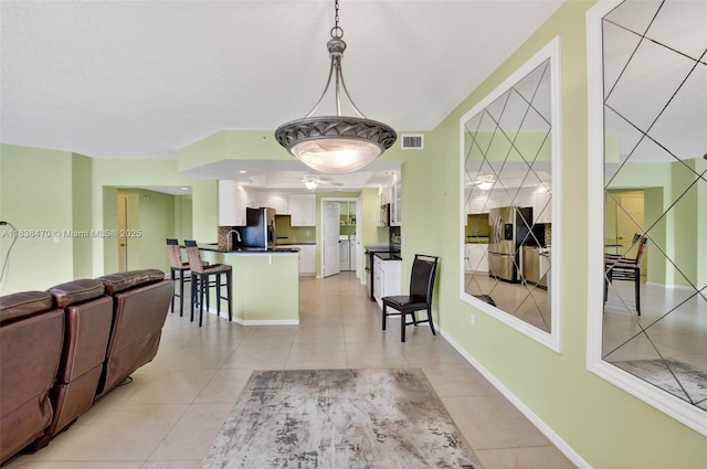 5938 Crystal Shores Dr Unit 103, Boynton Beach, FL 33437 - living room with light tile patterned floors, ceiling fan, and washing machine and clothes dryer