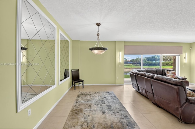 5938 Crystal Shores Dr Unit 103, Boynton Beach, FL 33437 - living room featuring light tile patterned floors and a textured ceiling