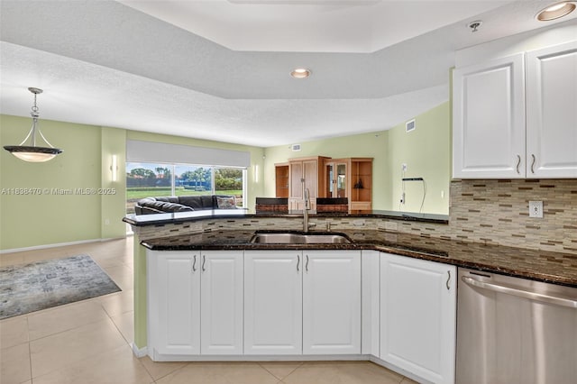 5938 Crystal Shores Dr Unit 103, Boynton Beach, FL 33437 - kitchen with dishwasher, dark stone countertops, open floor plan, white cabinetry, and backsplash