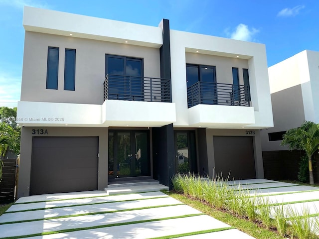 313 SW 10th St Unit A, Fort Lauderdale, FL 33315 - contemporary house featuring a garage, french doors, stucco siding, and a balcony