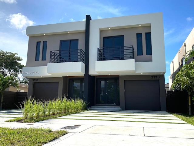 313 SW 10th St Unit A, Fort Lauderdale, FL 33315 - modern home with stucco siding, a garage, driveway, and a balcony