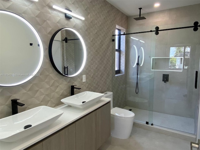 313 SW 10th St Unit A, Fort Lauderdale, FL 33315 - bathroom featuring a stall shower, double vanity, and tile walls