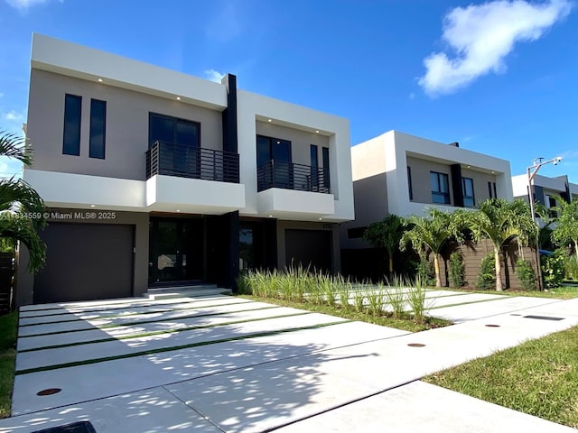 313 SW 10th St Unit B, Fort Lauderdale, FL 33315 - contemporary house featuring stucco siding, concrete driveway, a garage, and a balcony