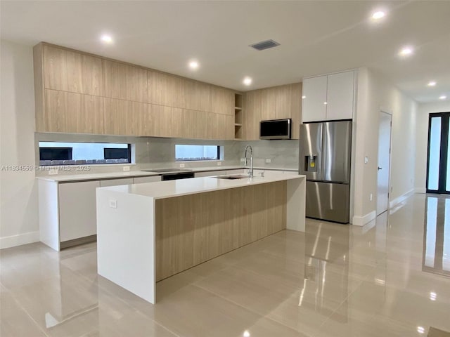313 SW 10th St Unit B, Fort Lauderdale, FL 33315 - kitchen with appliances with stainless steel finishes, modern cabinets, light countertops, a kitchen island with sink, and open shelves